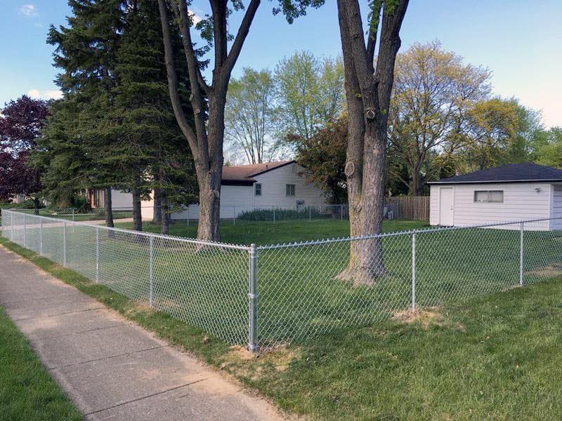 Galvanized chain-link fence securing a property perimeter