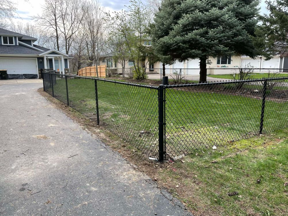 Galvanized chain-link fence enclosing a residential yard
