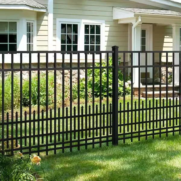 Black aluminum picket fence across the front lawn of a house