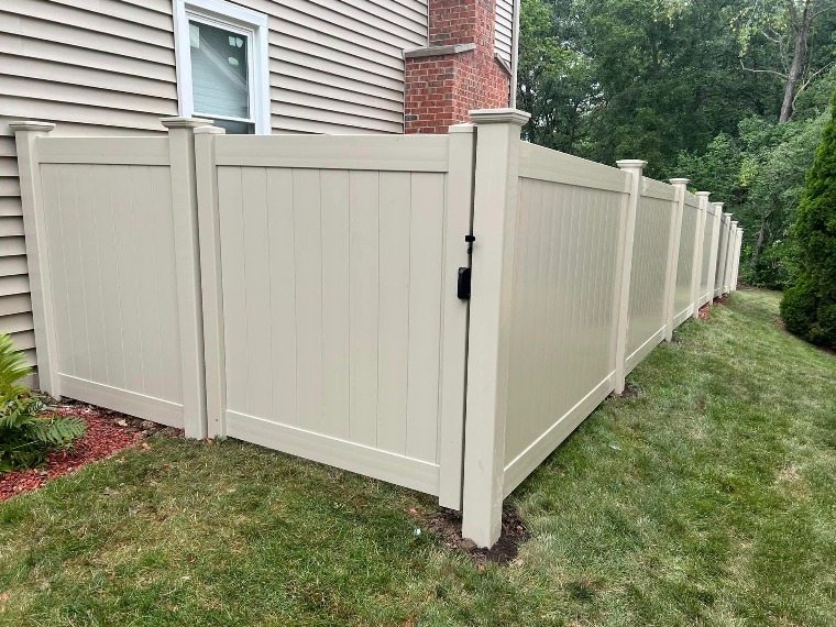 White vinyl privacy fence installed in an Arlington Heights area back yard