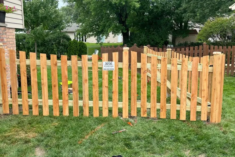 Cedar picket fence newly installed on a residential lot in Long Grove, IL